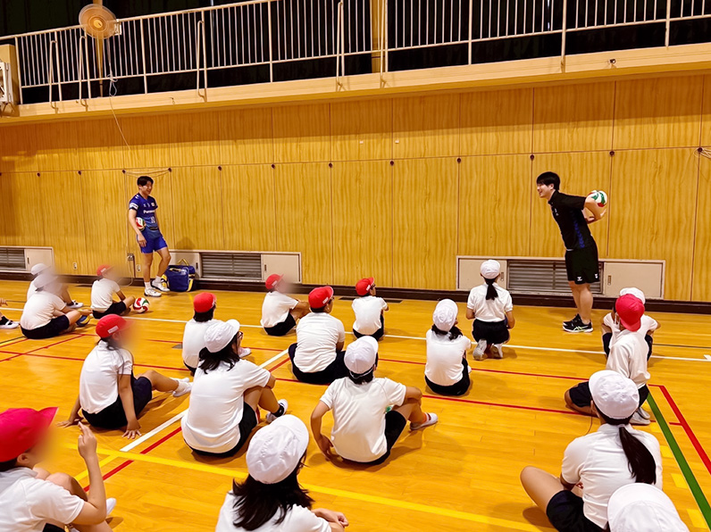 写真：お手本を見せるスタッフと見学する子供たち